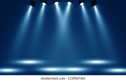 Spotlights illuminate empty stage blue background.
